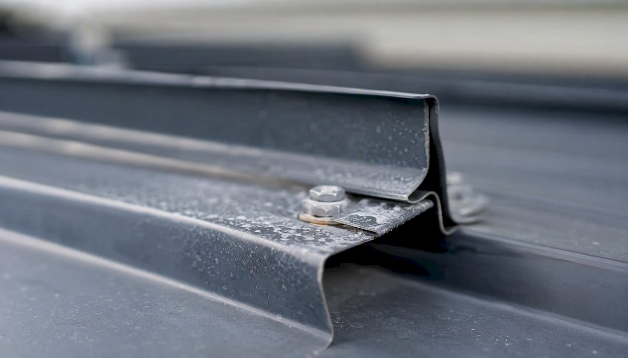 Coastal Roofing & Construction LLC | Top Metal Roof Warranty Options 2026: What Homeowners Must Check Close-up of metal roof fasteners with coastal corrosion risk