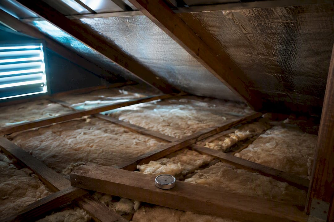 Insulated metal roof interior with vapor barrier