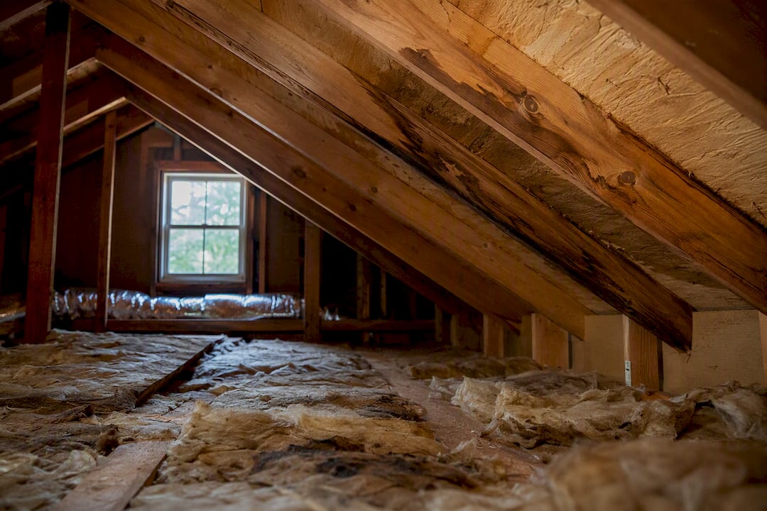 Attic water damage and stained insulation detail
